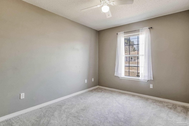 carpeted empty room featuring a textured ceiling, ceiling fan, and a healthy amount of sunlight