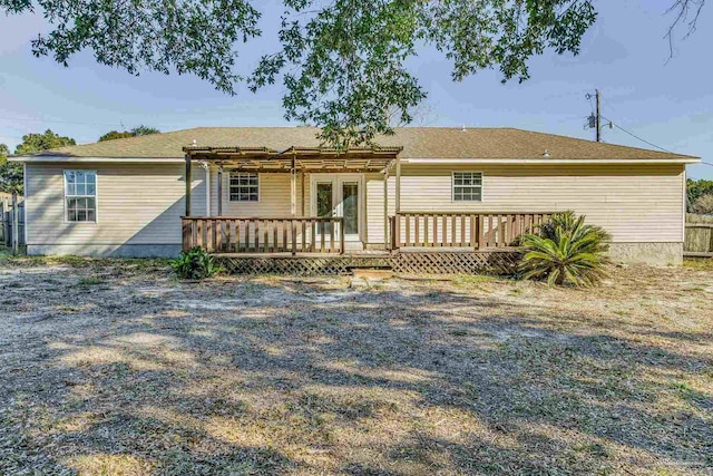 back of property with a pergola and a deck