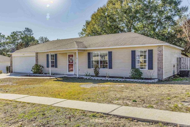 ranch-style house with central air condition unit, a front lawn, and a garage