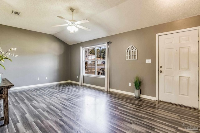 entryway featuring vaulted ceiling, ceiling fan, a textured ceiling, and dark hardwood / wood-style floors