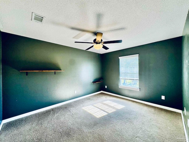 carpeted empty room featuring a textured ceiling and ceiling fan