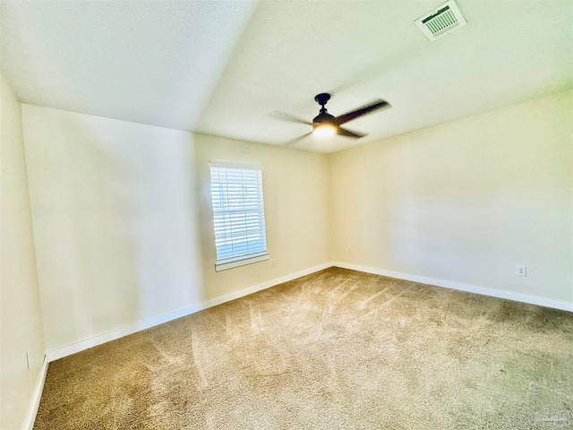 carpeted spare room with ceiling fan