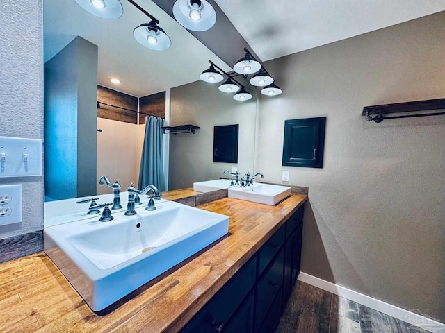 bathroom featuring vanity and curtained shower