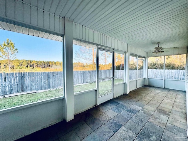 unfurnished sunroom featuring ceiling fan