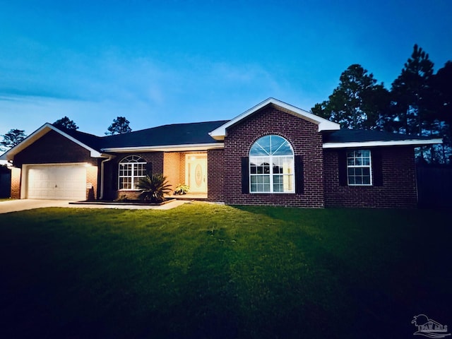 ranch-style house with a garage and a lawn