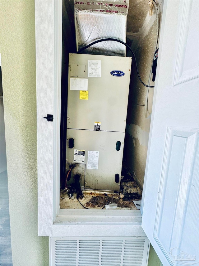 utility room featuring heating unit