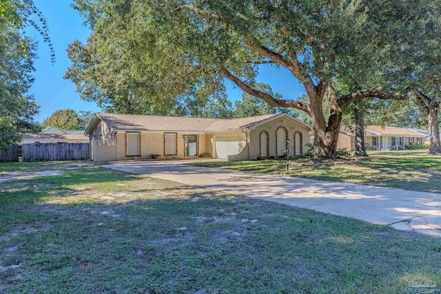 single story home featuring a front yard and a garage