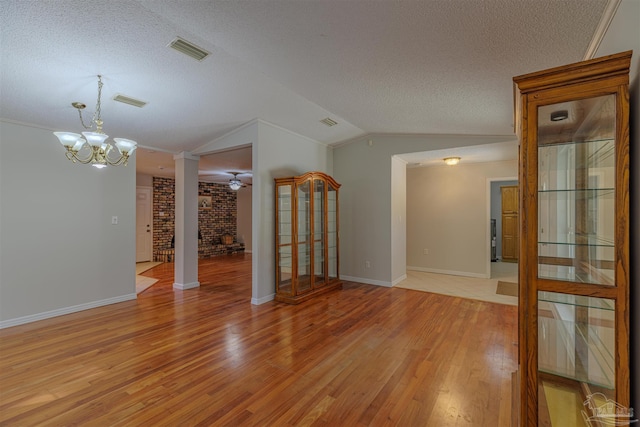 4679 E Spencer Field Rd, Pace, FL 32571 - unfurnished living room with visible vents, ornate columns, light wood-type flooring, and a textured ceiling