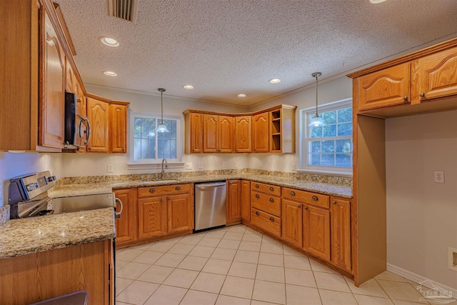 kitchen featuring pendant lighting, sink, a textured ceiling, appliances with stainless steel finishes, and light stone counters