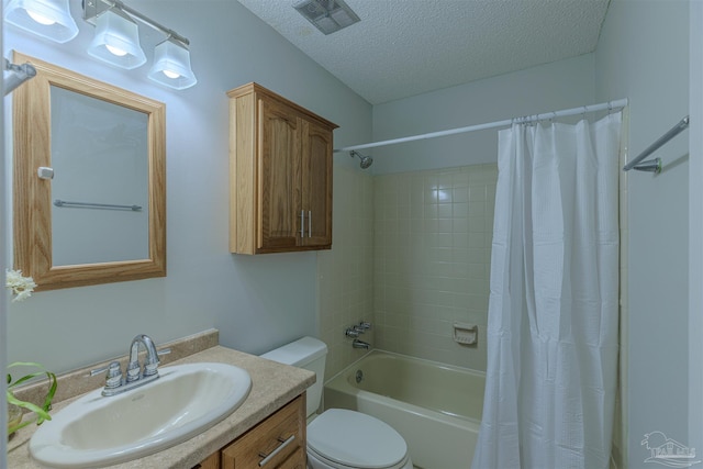 full bathroom featuring vanity, toilet, shower / bathtub combination with curtain, and a textured ceiling