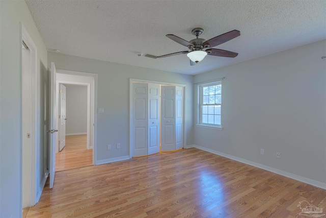 4679 E Spencer Field Rd, Pace, FL 32571 - unfurnished bedroom with a textured ceiling, light wood finished floors, and baseboards