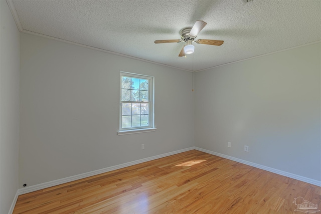 empty room featuring ceiling fan, ornamental molding, a textured ceiling, and light hardwood / wood-style flooring