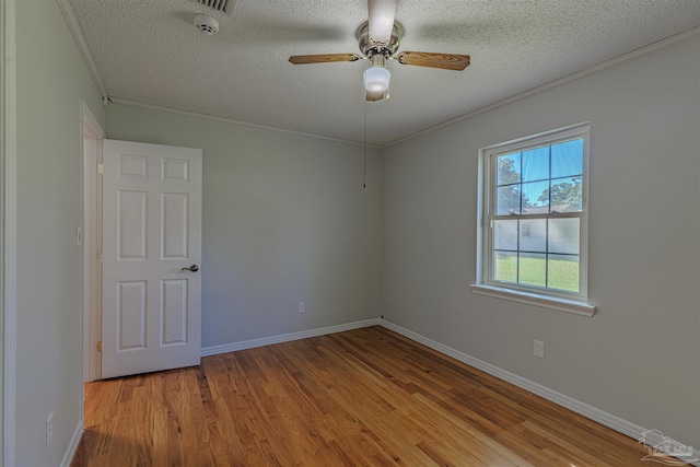 4679 E Spencer Field Rd, Pace, FL 32571 - empty room featuring a ceiling fan, baseboards, ornamental molding, a textured ceiling, and wood finished floors