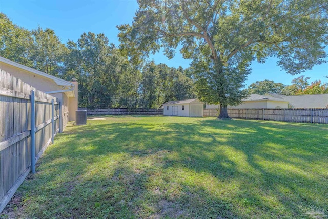 view of yard with central AC and a storage shed