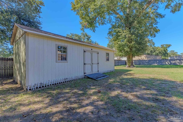 view of outbuilding featuring a yard