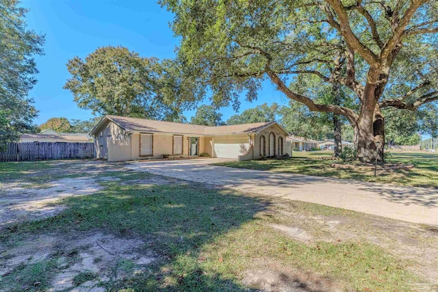 ranch-style house with a garage and a front lawn