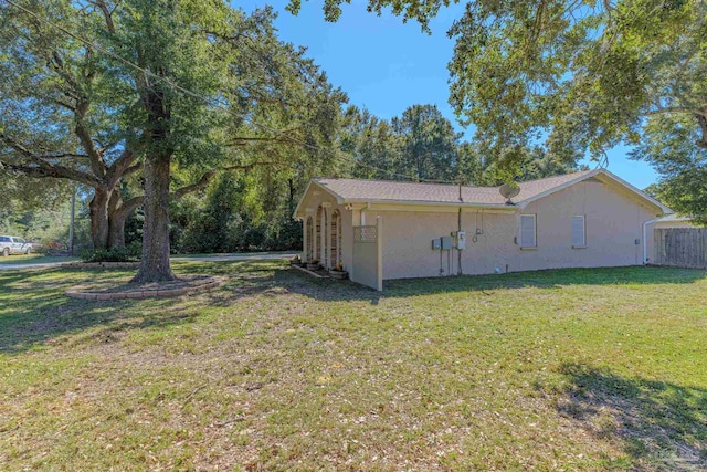 view of property exterior featuring a lawn