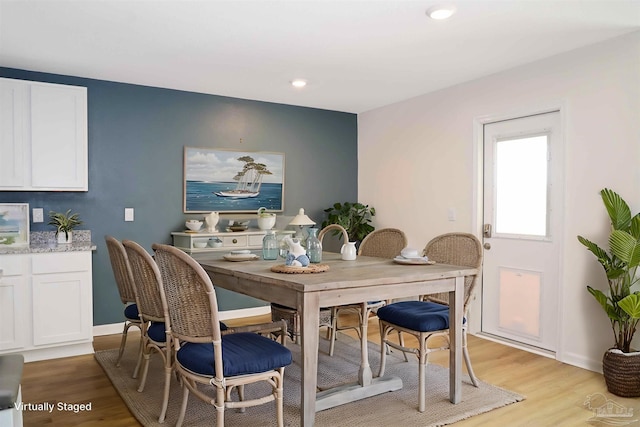 dining space with light hardwood / wood-style flooring