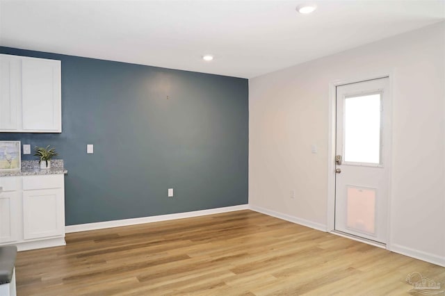 unfurnished dining area with light wood-type flooring