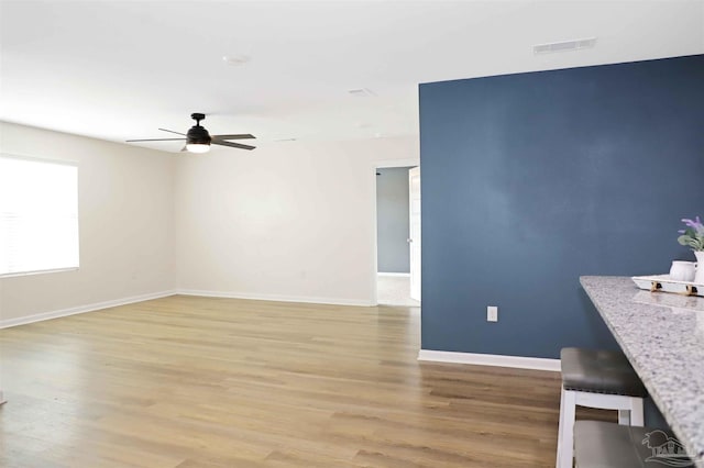 interior space featuring light hardwood / wood-style floors and ceiling fan