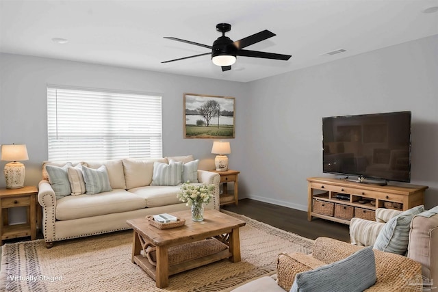 living room with ceiling fan and dark hardwood / wood-style flooring