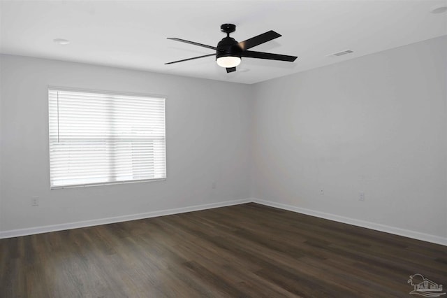 empty room featuring ceiling fan and dark hardwood / wood-style floors