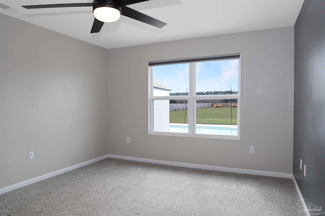 spare room featuring carpet floors and ceiling fan