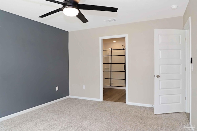 unfurnished bedroom with light colored carpet and ceiling fan