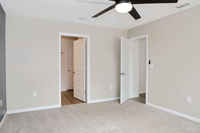 unfurnished bedroom with light carpet and ceiling fan