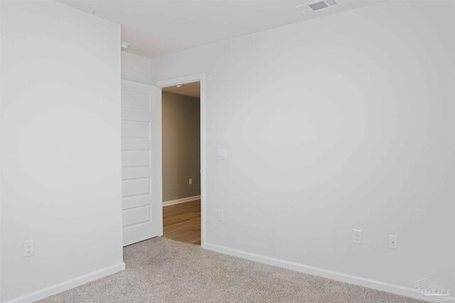 unfurnished room with light colored carpet