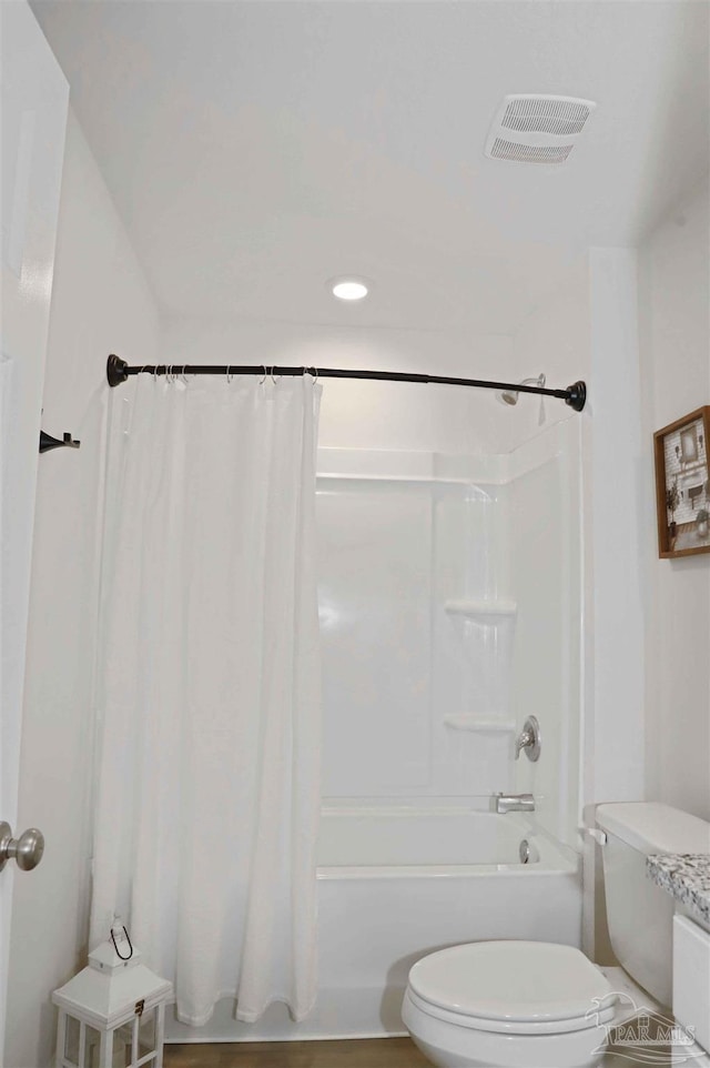 bathroom with shower / tub combo with curtain and toilet