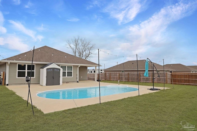 view of pool featuring a patio, a yard, and a storage unit