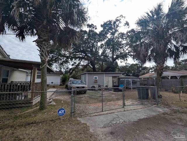 view of front of house with a gate, driveway, and fence