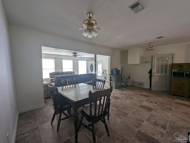 dining room featuring visible vents, baseboards, and ceiling fan