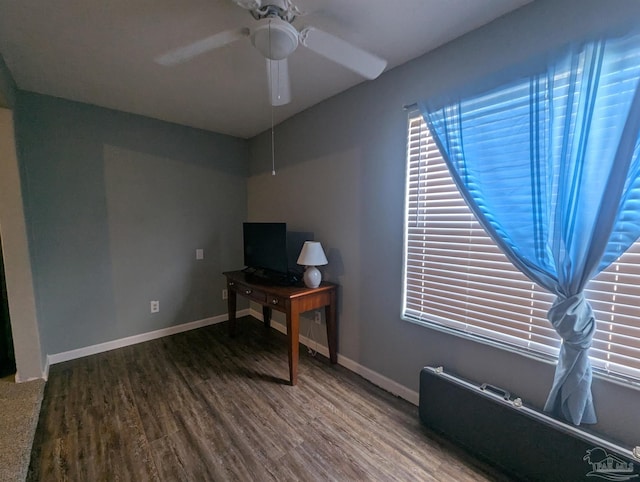 office space with a ceiling fan, baseboards, and wood finished floors