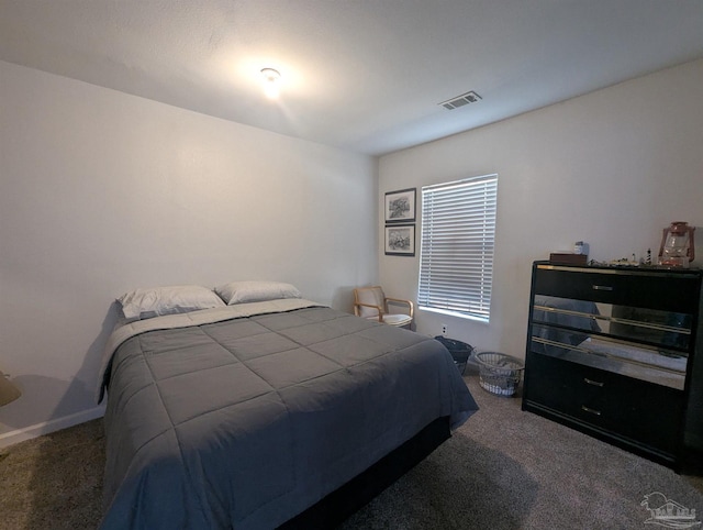 bedroom with visible vents and carpet