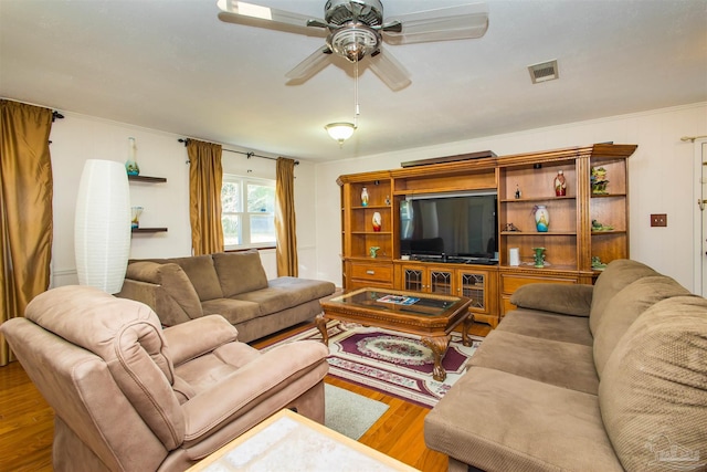 living room with wood-type flooring and ceiling fan