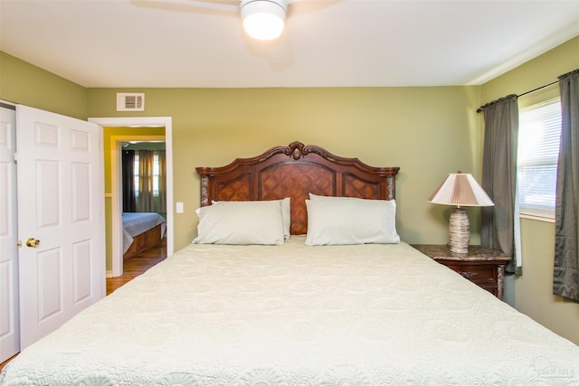 bedroom featuring wood-type flooring and ceiling fan