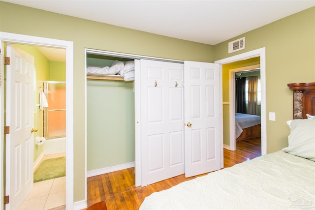 bedroom featuring wood-type flooring and a closet