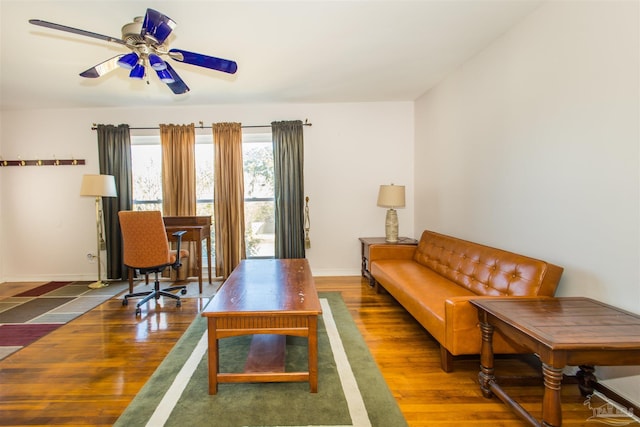 living room with dark hardwood / wood-style flooring and ceiling fan