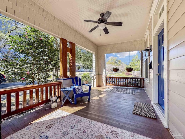 deck with a ceiling fan and covered porch