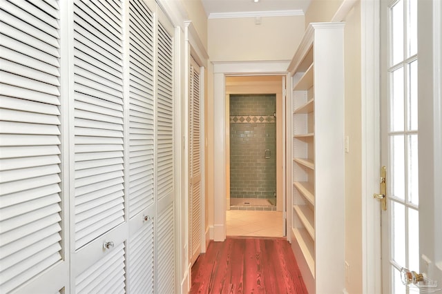 hallway featuring ornamental molding and dark wood finished floors