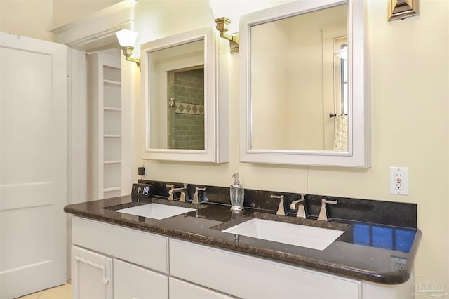 bathroom featuring a sink and double vanity