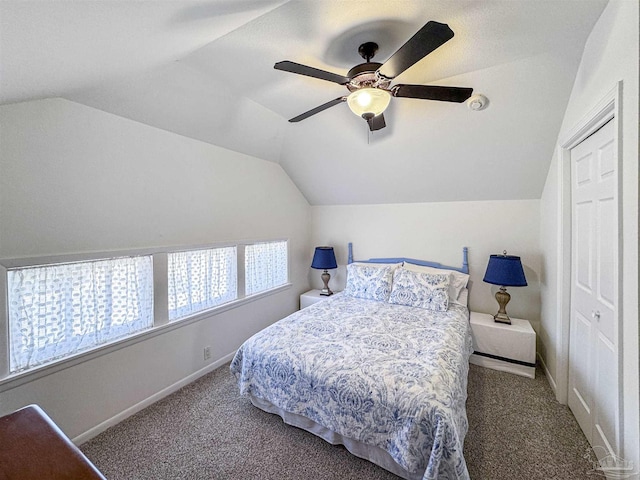 carpeted bedroom with baseboards, vaulted ceiling, and a ceiling fan