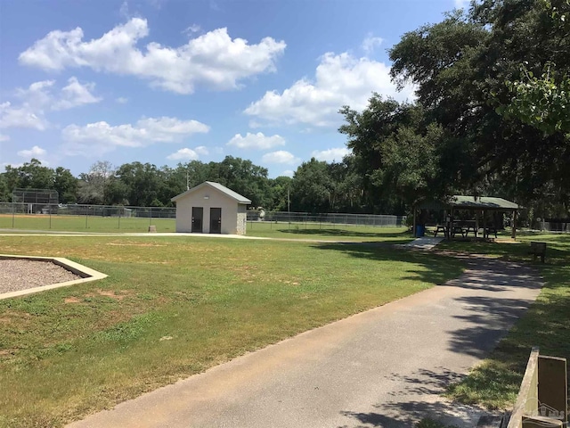 surrounding community with a gazebo and a yard