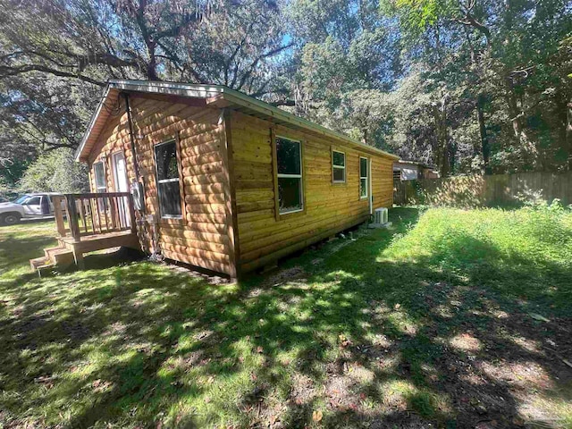 view of side of home with a yard