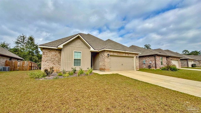 view of front of home featuring cooling unit, a front yard, and a garage