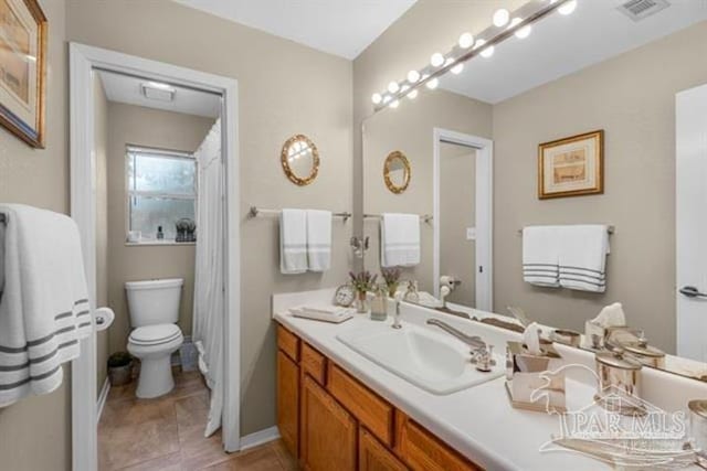 bathroom featuring vanity and toilet