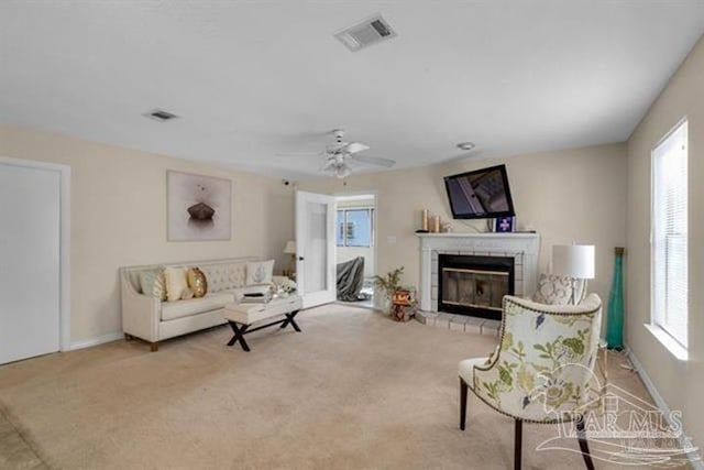 carpeted living room with ceiling fan and a wealth of natural light