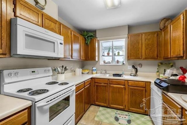 kitchen with light tile patterned floors and white appliances